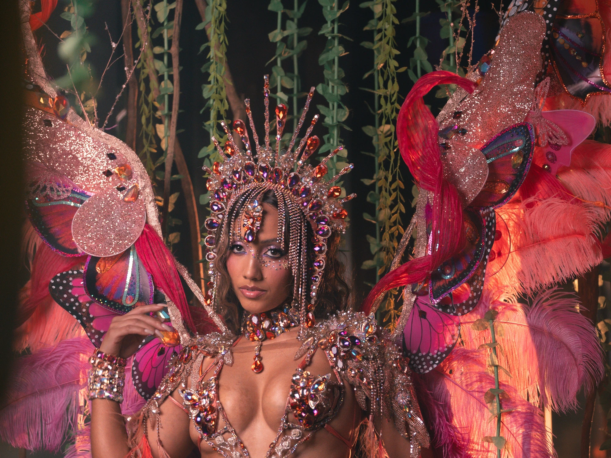 The HALO costume shown in full — jewelled bra, belt and leg chains beneath a feathered backpack at full span.