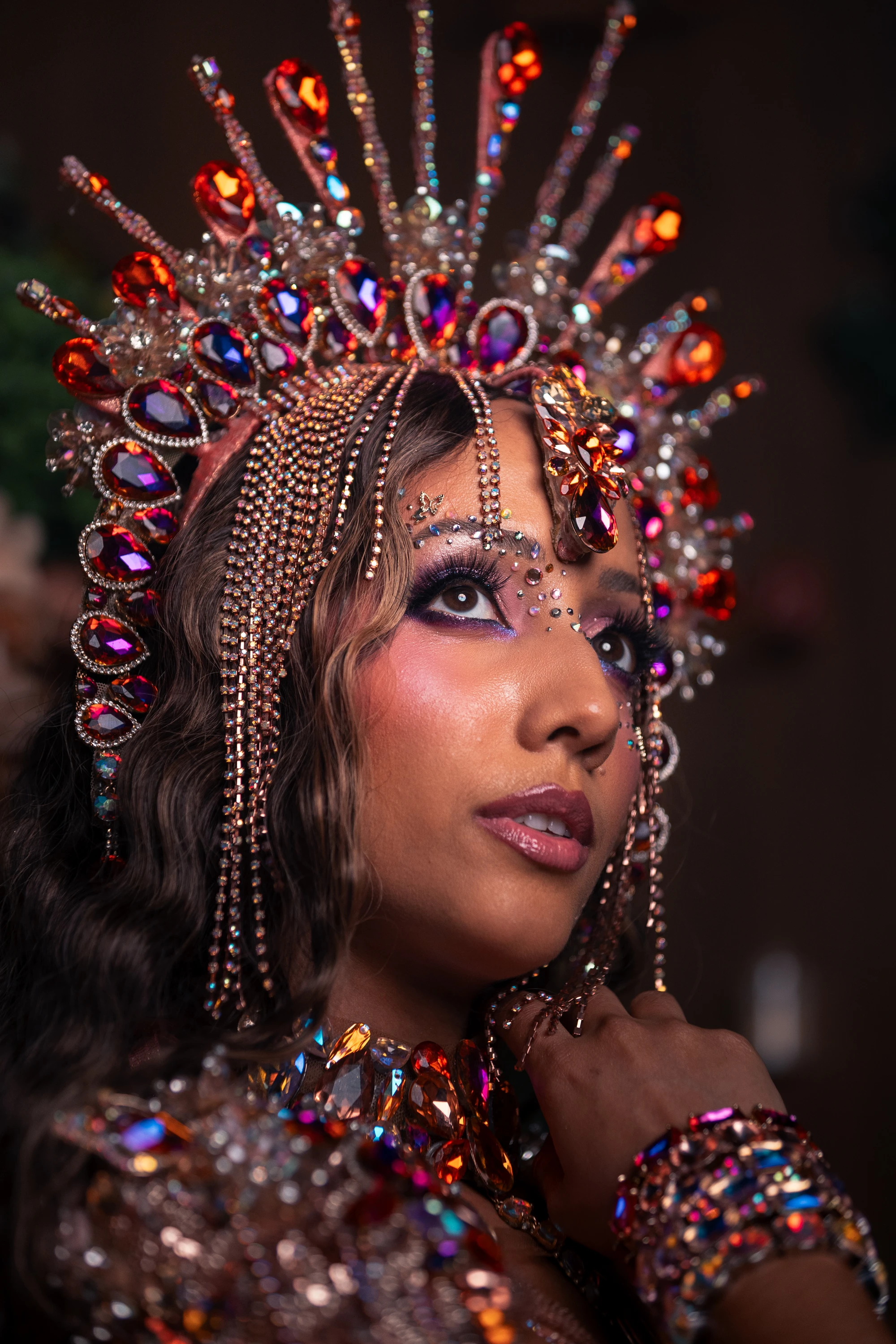 The HALO costume shown in full — jewelled bra, belt and leg chains beneath a feathered backpack at full span.
