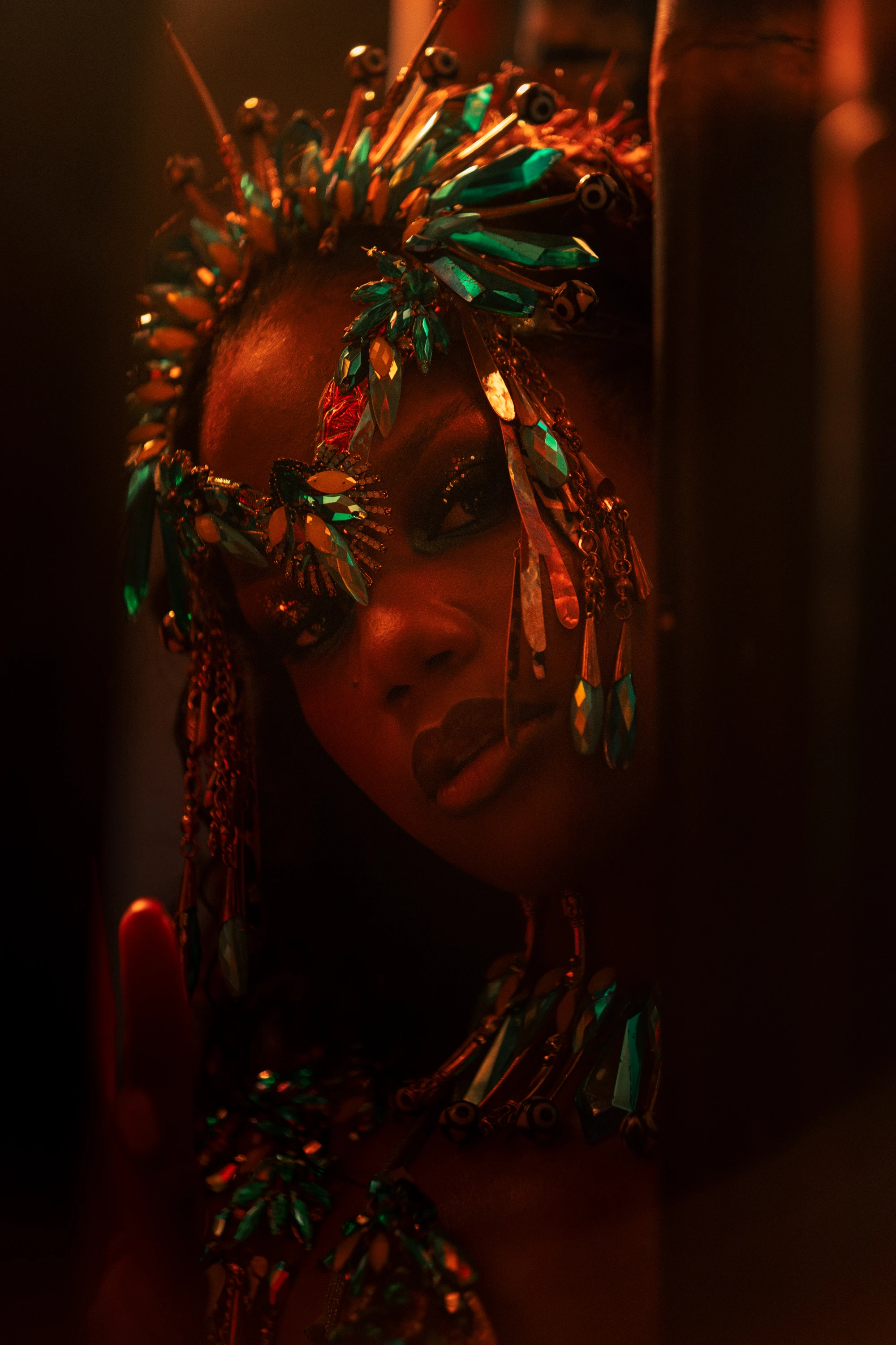 The IVY costume shown in full — jewelled bra, belt and leg chains beneath a feathered backpack at full span.