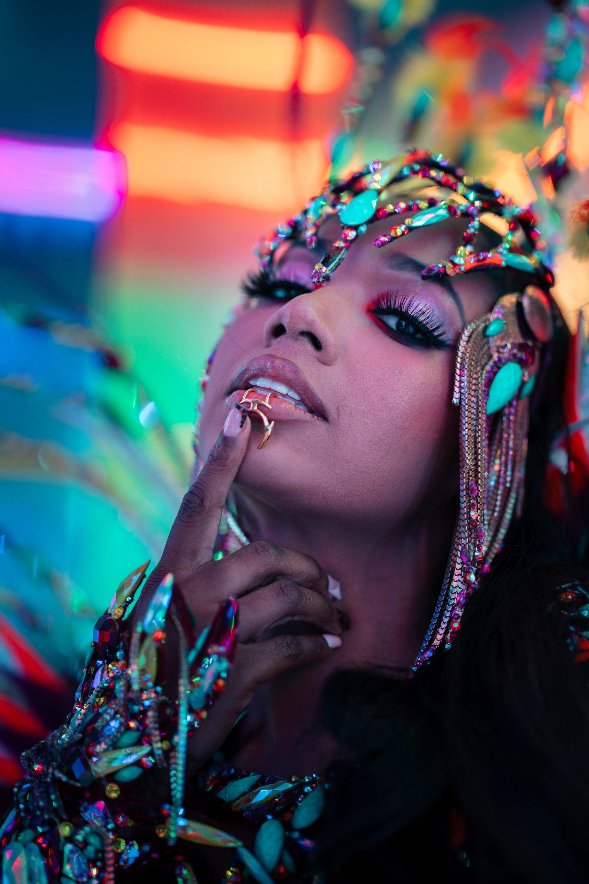 The RUSE costume shown in full — jewelled bra, belt and leg chains beneath a feathered backpack at full span.